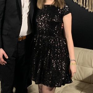 Little black dress. Sequin details with low cut back